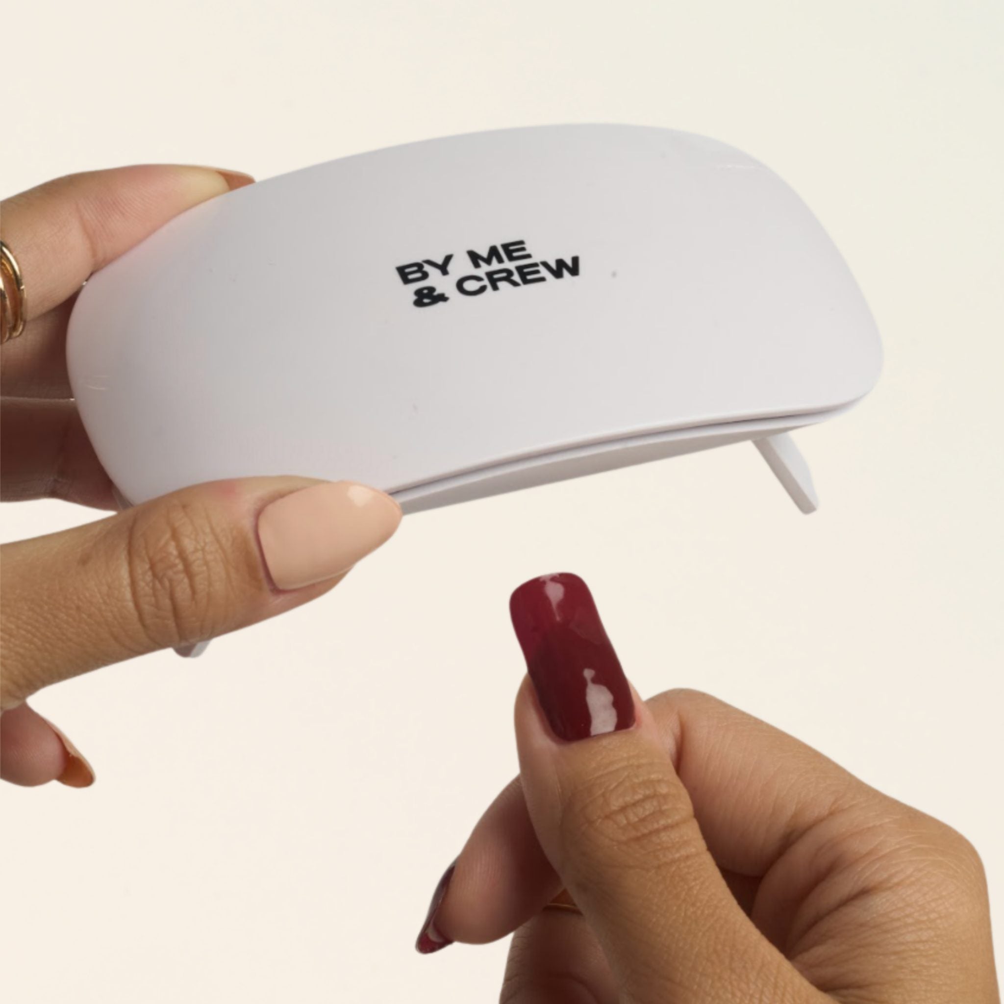 Compact By Me & Crew UV lamp held in hand – small enough to take anywhere