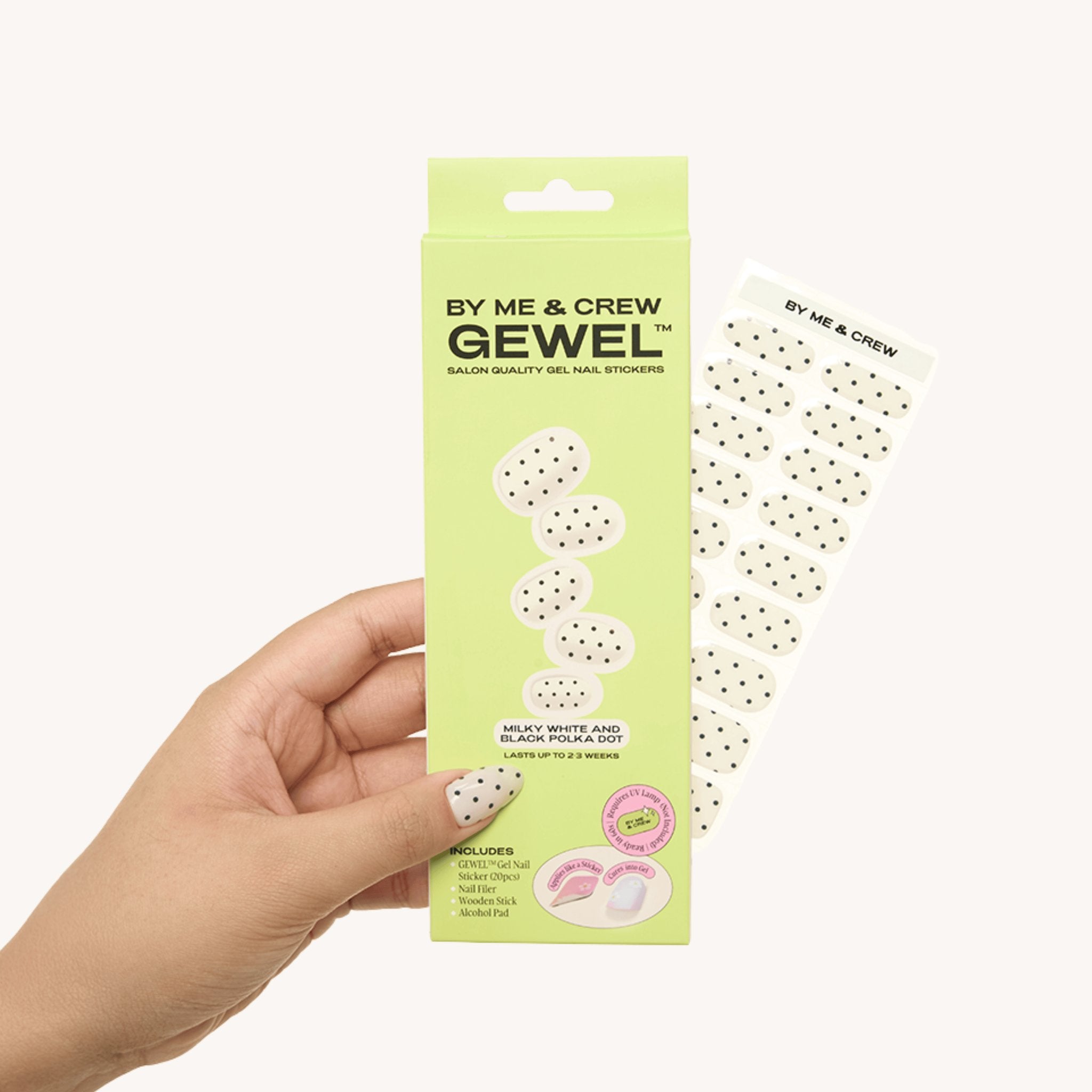 Hand holding Milky White & Black Polka Dot GEWEL™ box and nail sticker sheet by By Me & Crew