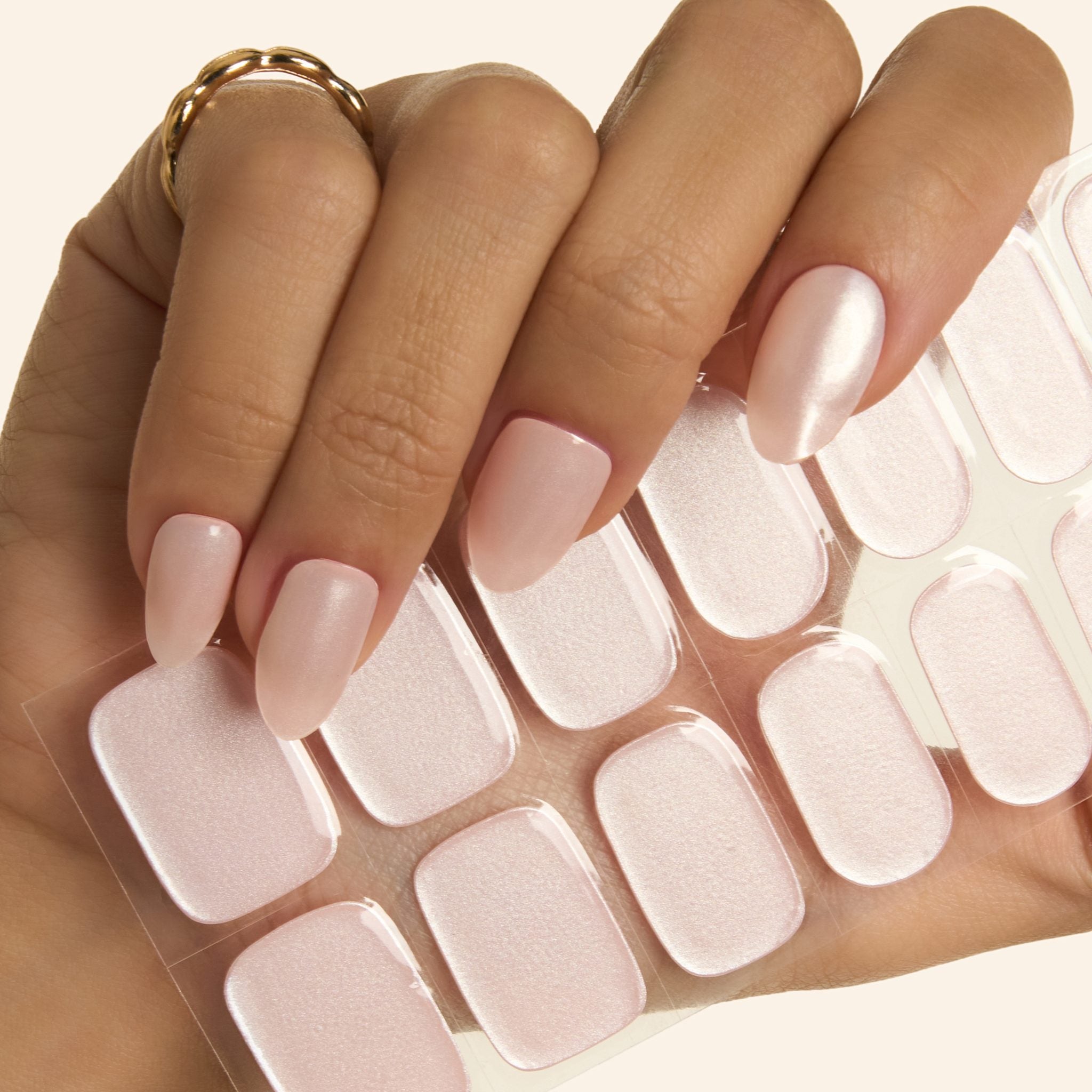 Close-up of Pink Glazed Donut GEWEL™ nails and sticker sheet – soft pink with a pearl glazed finish
