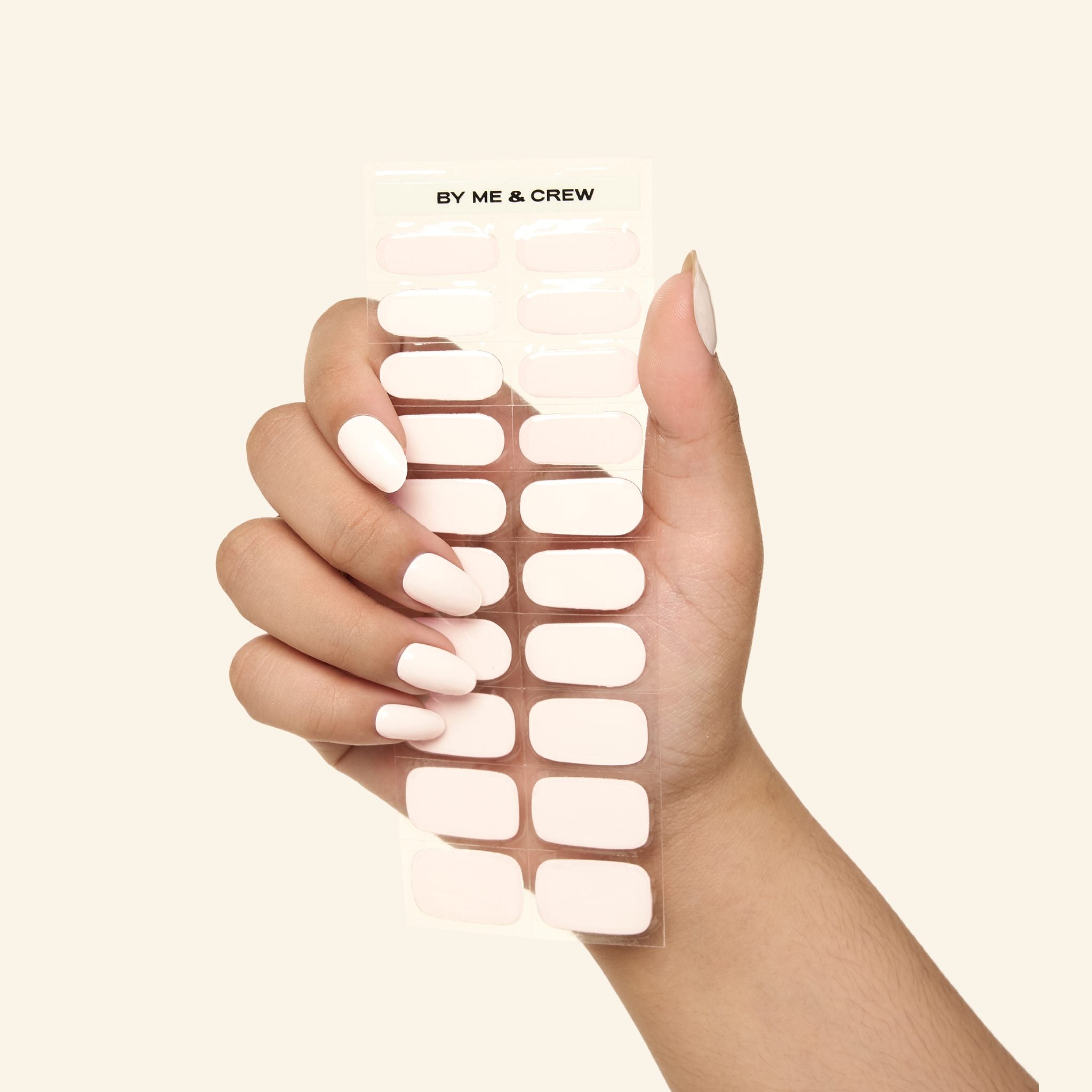 Gentle Pink GEWEL™ semi-cured gel nail sticker sheet held in hand