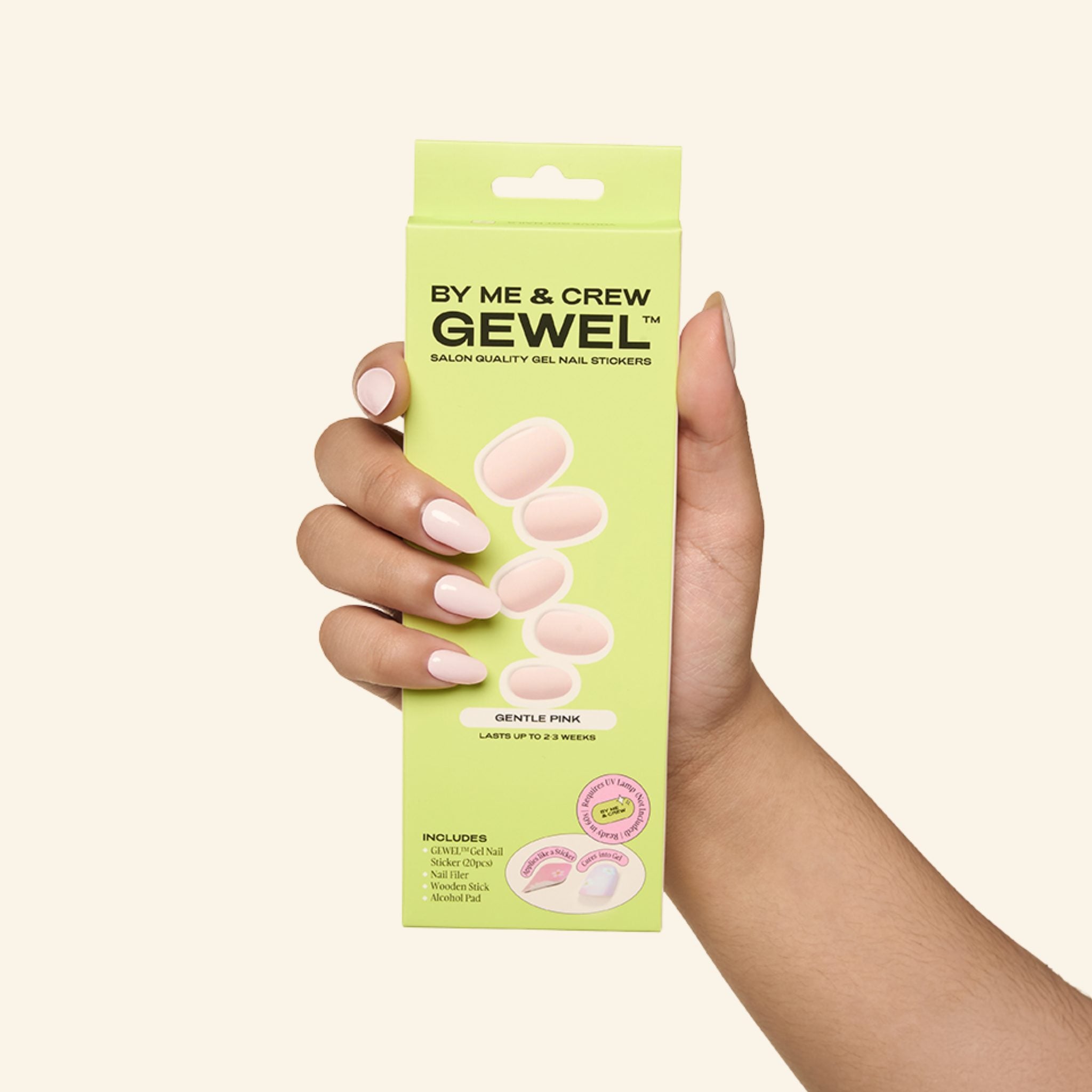 Hand holding Gentle Pink GEWEL™ nail stickers box by By Me & Crew